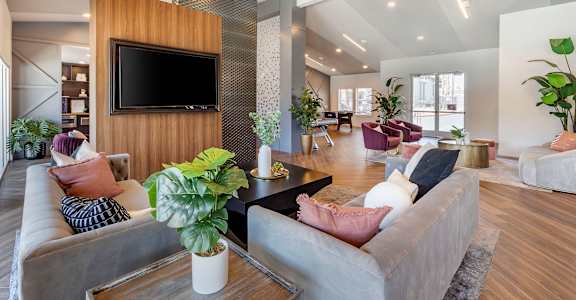 a living room with couches and a tv at Paisley and Pointe Apartments, Las Vegas