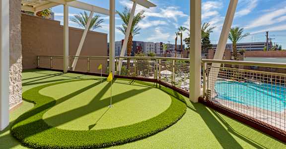 a backyard with a golf course and a pool at The Rays at Vegas Towers Apartments, Nevada, 89119
