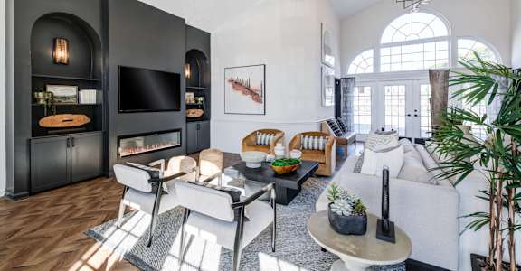 A modern living room with a fireplace and a large window.