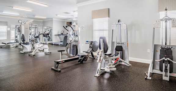 A gym with a variety of exercise equipment.