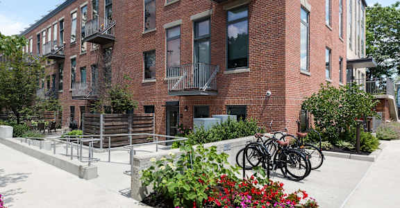 A red brick building with a bicycle parked in front.