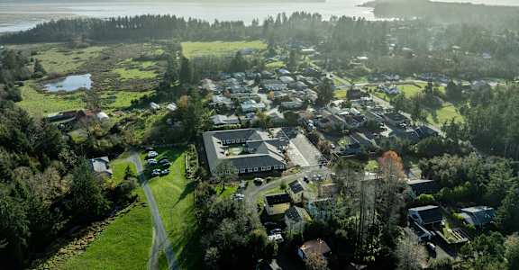 A small town with a large body of water in the background.