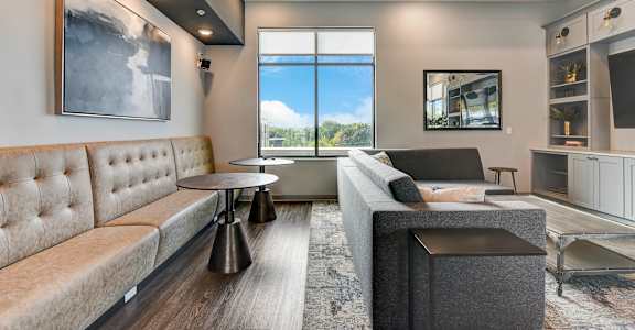 a living room with couches and a window