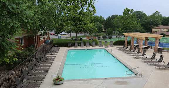 a resort style pool with lounge chairs around it at Lodge of Overland Park Apartments, Overland Park , 66212
