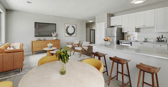 A modern kitchen with a dining table and chairs.