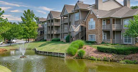 a lake with a fountain in front of a building at Appling Lakes, Cordova