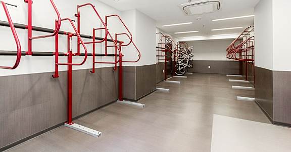 a row of red bike racks in a white walled room