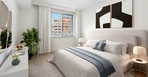 a bedroom with a bed and a large window