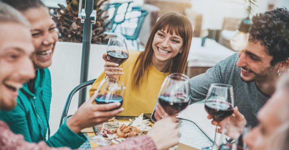a group of people sitting at a table drinking wine at The Standard on 32nd, West Fargo