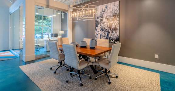 A conference room with a long table and chairs.