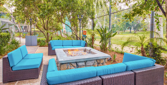 a lounge area with blue couches and a fire pit  at Rancho Los Feliz, California