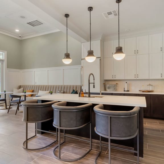 a kitchen with a large island with bar stools at Madison on the Meadow in TX 77477