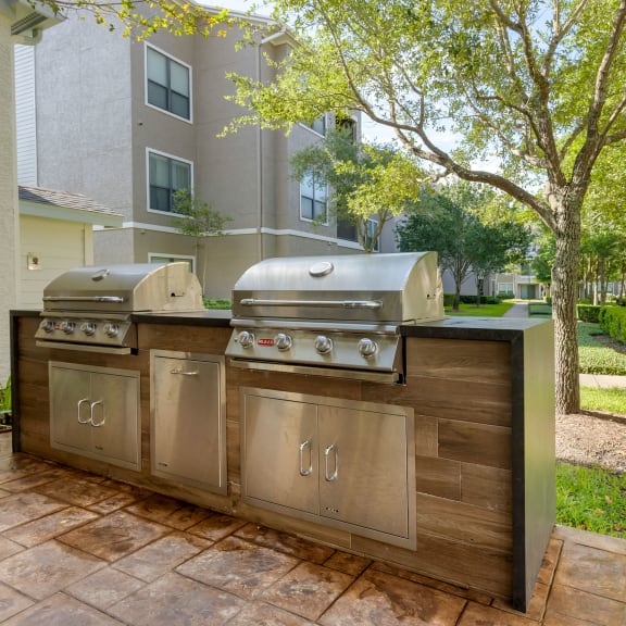 the preserve at ballantyne commons outdoor kitchen with two grills at Summerwind in TX 77584