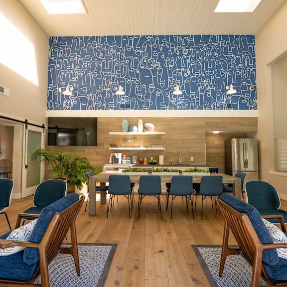Anton Pacific patio with a table and chairs in front of an apartment building in Santa Cruz