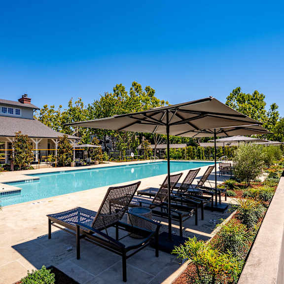 Anton Pacific patio with a table and chairs in front of an apartment building in Santa Cruz
