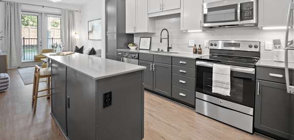 a kitchen with stainless steel appliances and white cabinets