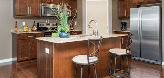 A kitchen with a bar stool and a counter.