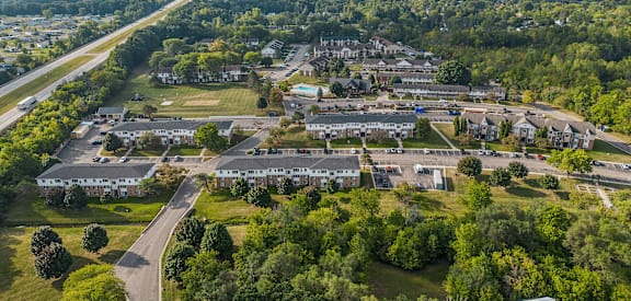 A bird's eye view of a residential area with houses and a road.