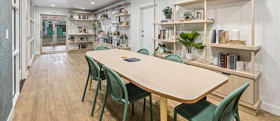 Conference room with a wooden table and green chairs  at Citrine Hills, Ontario, CA 91761