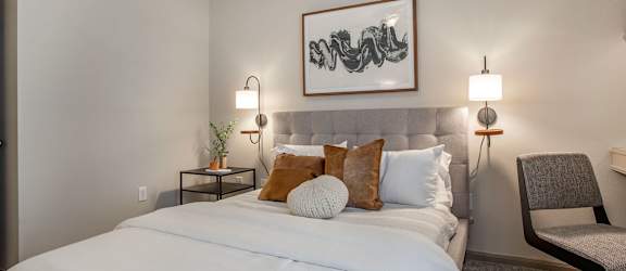 a bedroom with a large white bed and pillows at Reserve by the Lake in Houston, Texas 77084