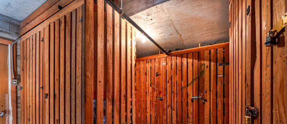 A room under construction with wooden walls and doors.