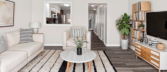 A living room with a white couch and a coffee table.