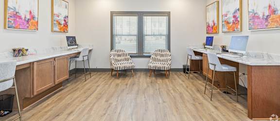 A room with wooden floors and a window with blinds.