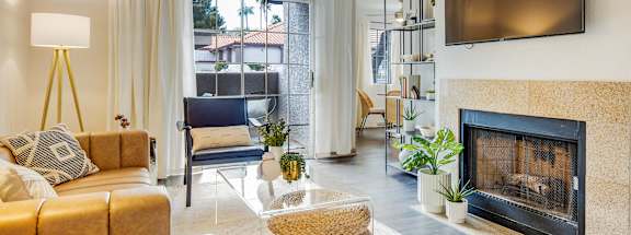 a living room with a fireplace and a tv