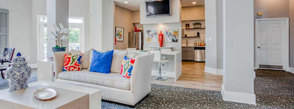 A living room with a white couch and a television.