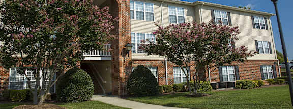 A building with a brick facade and a white trim around the windows.