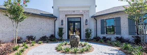 the front of a house with a courtyard and a fountain at Residences at 393 North Apartments, Florida