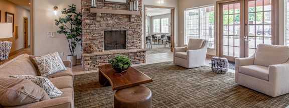 A living room with a stone fireplace and a couch.