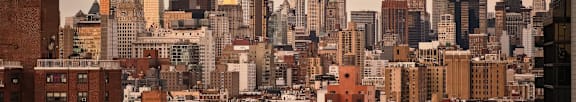 A cityscape with a mix of modern and older buildings.