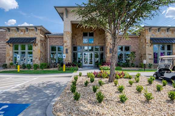 a building with a golf cart parked in front of it at Discovery at Craig Ranch, McKinney, TX