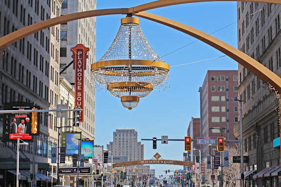 A street scene with a traffic light and a sign for Playhouse Square.