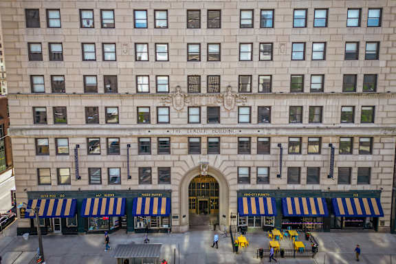 A large building with a striped awning and a sign that says "The Brownstone".