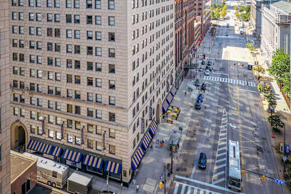 A city street with a white bus and cars.