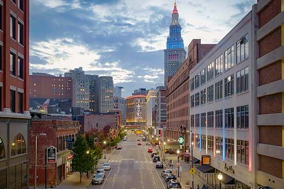 A city street with a tall tower in the background.