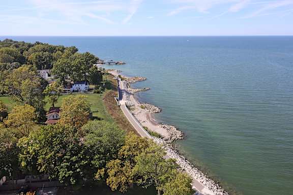 A coastal landscape with a road running parallel to the shore.