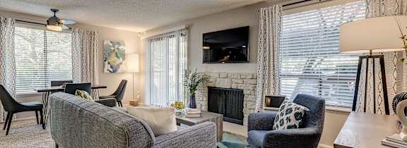 A living room with a white couch and a coffee table.