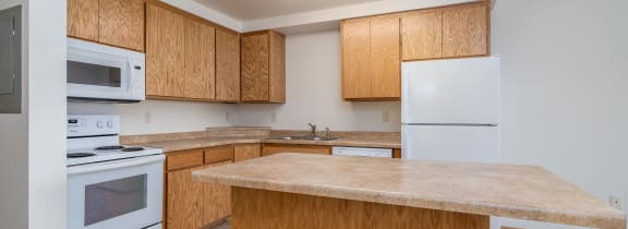 Grand Forks, ND Desoto Estates | an empty kitchen with a stove microwave and sink