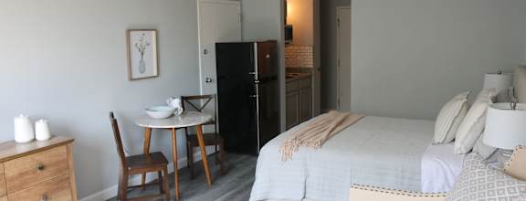 a bedroom with two beds and a couch and a table at Schaefer Ridge Apartments, Branson , MO