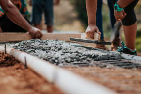a group of people working on a building project with wood