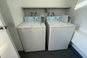 Washing machines in laundry room at Eucalyptus Apartments in Moreno Valley, California.