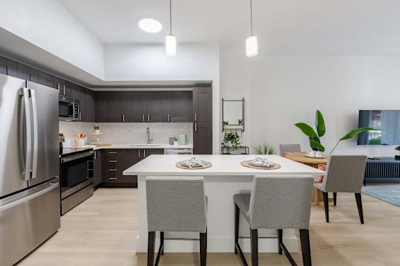 a living room with a kitchen and an open floor plan at One Plantation in  Florida 33324