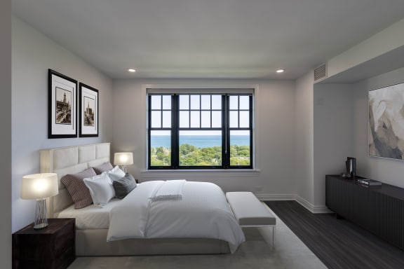 a white bedroom with a large bed and a window at the Belden Stratford in Chicago, Illinois 60614
