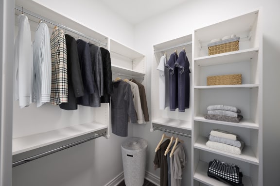 a walk in closet with white shelves and a closet organizer at the Belden Stratford in Chicago, Illinois