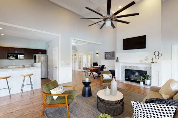 an empty living room with a fireplace and wood flooring at OLiVE DTLA in Los Angeles, California