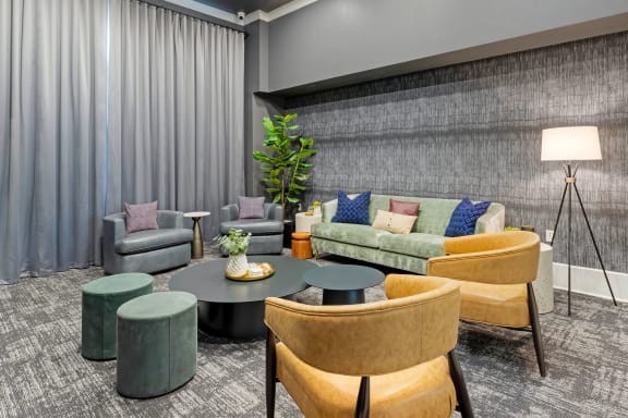 a living room with couches and chairs and a table at Madison on the Meadow in Stafford, TX 77477