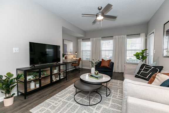 A kitchen with a bar stool and a table with chairs.